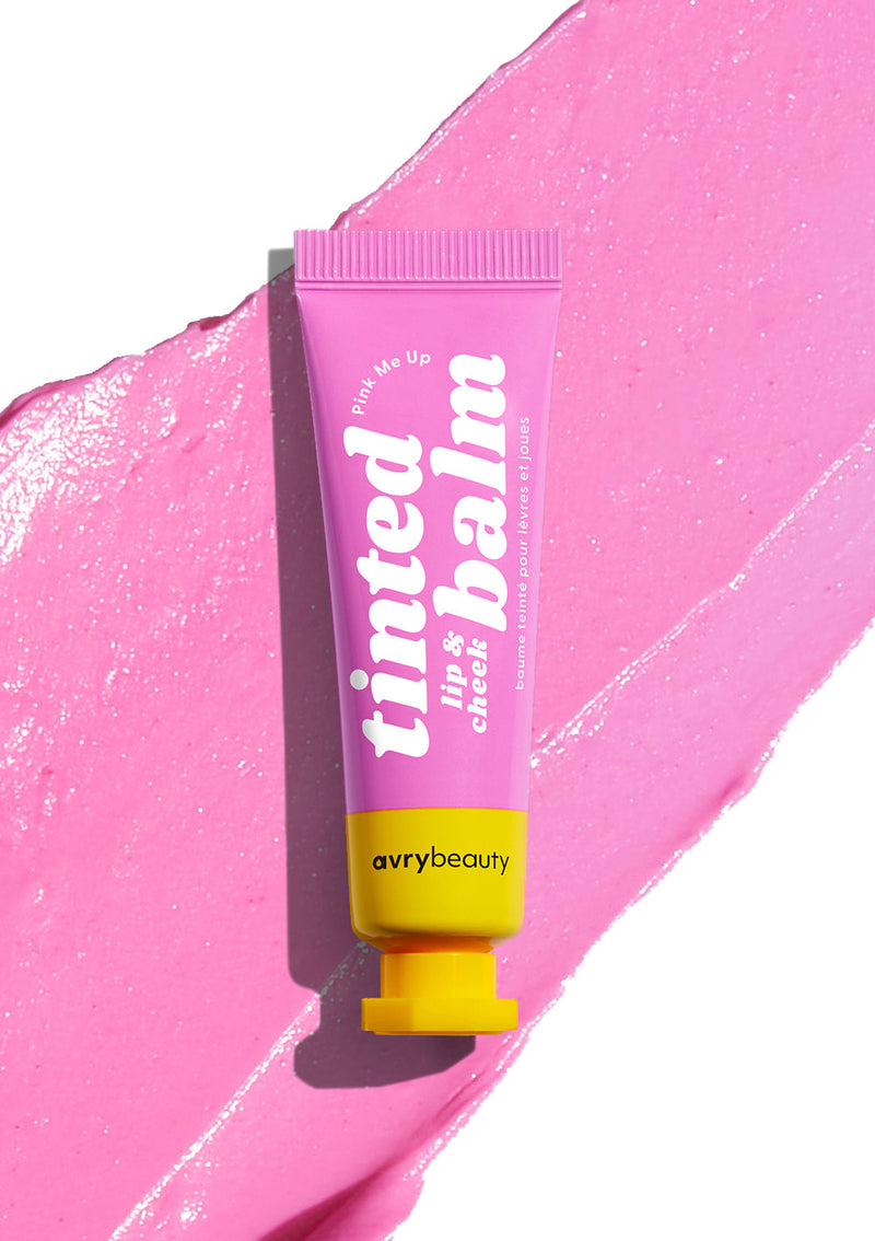 AvryBeauty’s Pink Me Up Lip & Cheek Tinted Balm texture splayed out on a white background with its vegan makeup tube placed on top.