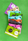 Gel-Ohh! jelly spa pedicure packets in various scents, laid out on green, jellied texture.