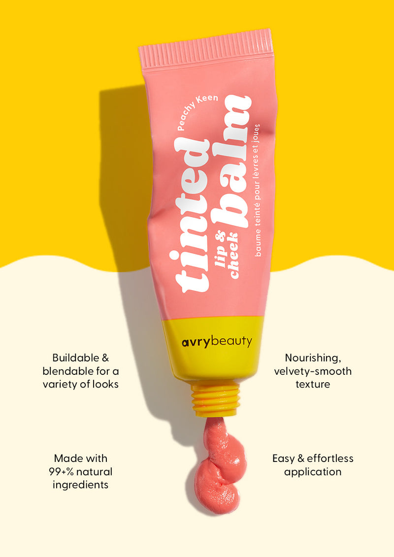AvryBeauty’s Peachy Keen Lip & Cheek Tinted Balm being squeezed out of the tube onto a beige and yellow background, with callouts detailing its skin benefits.