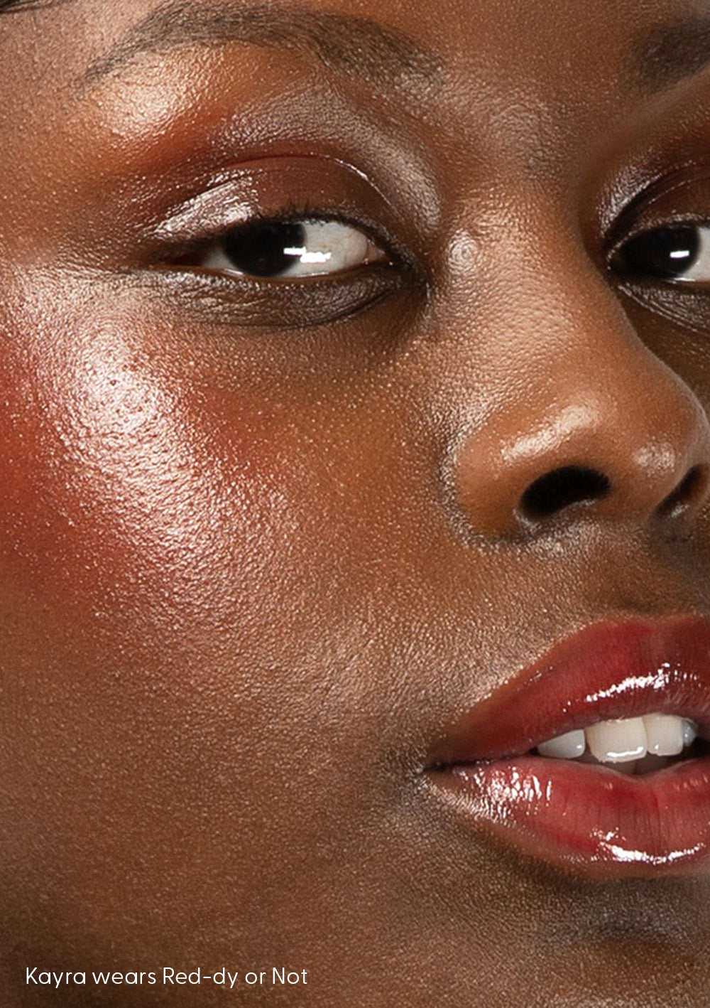 Kayra shines in AvryBeauty’s Red-dy or Not Lip & Cheek Tinted Balm, a versatile vegan makeup essential applied to her cheeks, lips, and eyelids.
