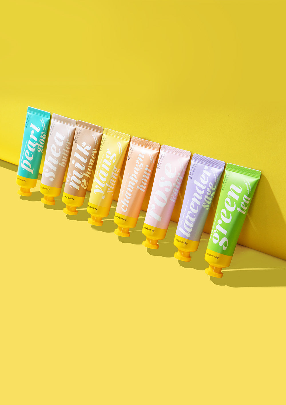 Assorted lineup of Shea Butter Lotions against a vibrant yellow backdrop.