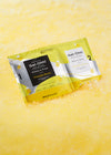 Shown is the Gel-Ohh spa foot soak kit in the scent Pineapple Breeze. It’s resting in a yellow jelly texture.