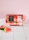 Shown is the Gel-Ohh jelly spa foot soak kit in the scent Watermelon Sugar. Around it are slices of watermelon.